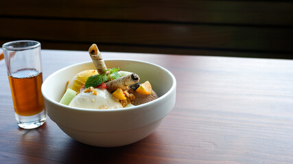 Fresh fruit with scoops of creamy ice cream