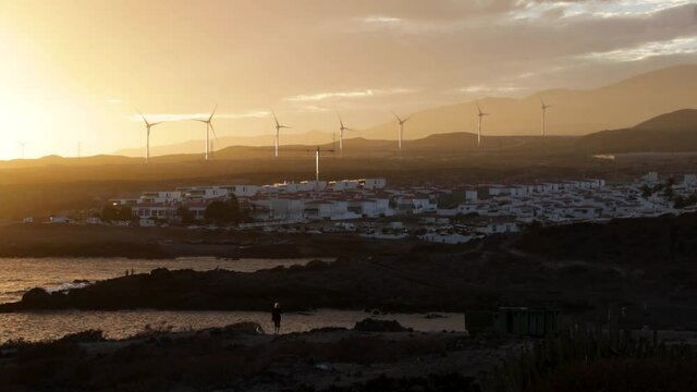 A spectacular sunset over The Abades town with the turbines in the distance, Tenerife