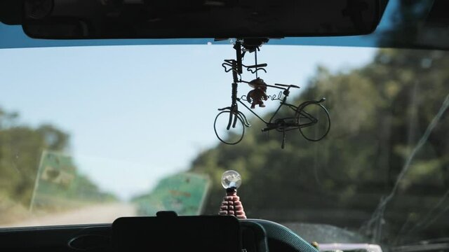 knick knack hanging on car rearview mirror