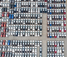Aerial view rows of new cars waiting to be dispatch and shipped, New cars lined up in the port for import export.
