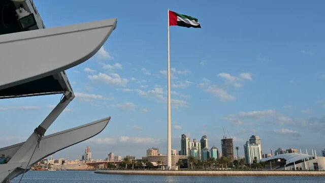 Flag of the United Arab Emirates waving in the air cloudy Blue sky in Background, Sharjah Flag Island, Sharjah city,  UAE National Day, 4k Video