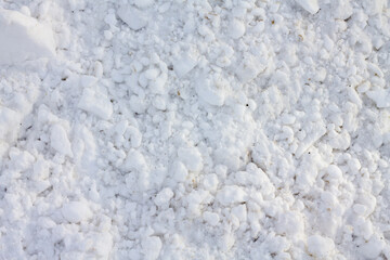 Snow in chunks. Snowy road. Winter background.