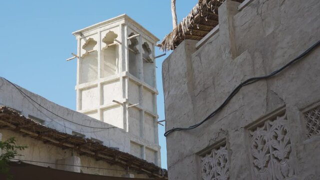 Wind Tower Of A Traditional Building Against Clear Blue Sky - Al Fahidi Neighborhood In Dubai - low angle, panning left