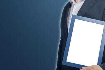 mockup businessman holding diploma frame on blue background. man holding empty picture certificate...