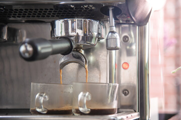 Espreesso shot coffee pouring from coffee machine