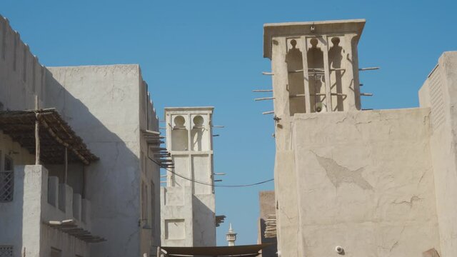 Typical Buildings With Wind Tower In Al Fahidi Against Blue Sky In Dubai, UAE. - Handheld, Wide Shot