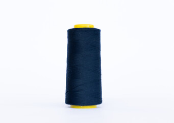 Dark blue bobbin thread isolated in white background. close up thread-like yarn for sewing.
