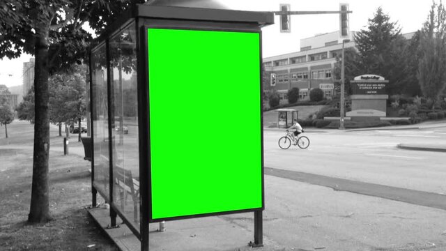 Green billboard for your ad on the bus station with black and white toned background