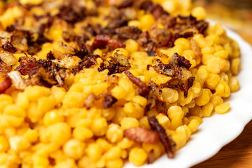 Close up of pea porridge with onions and bacon in the white plate.