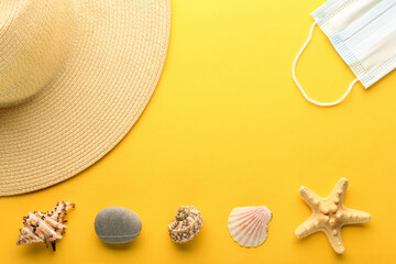 Tourist theme: hat, seashells, starfish, rock, a medical mask on a bright yellow background, center space for text. The concept of protection against coronavirus. Banner.