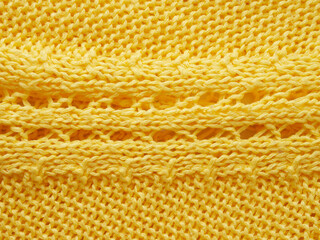 Knitted background. Knitted texture. A sample of knitting from wool. Knitting Pattern.