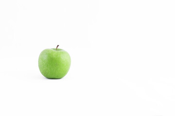 A ripe green apple full of vitamins and health benefits on a white background