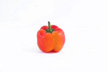 Red sweet bell pepper filled with fresh vitamins and benefits on a white background