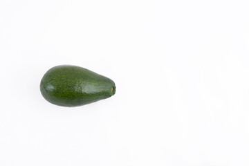 Fresh green unpeeled avocado full of vitamin on white background