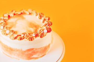 Beautiful carrot cake on a stand. Sweets for any occasion. Birthday and Christmas present. Opposite yellow background