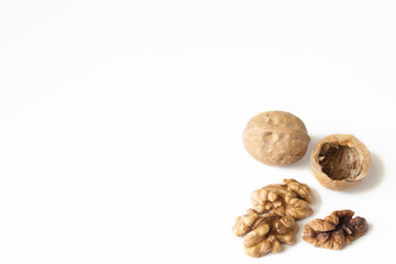 Walnuts peeled and shelled on a white background.