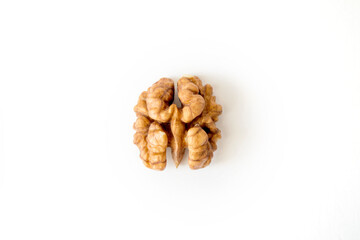 Half of a walnut looks like a brain on a white background.