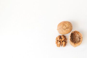 Walnuts peeled and shelled on a white background.