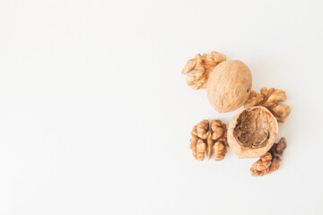 Walnuts peeled and shelled on a white background.