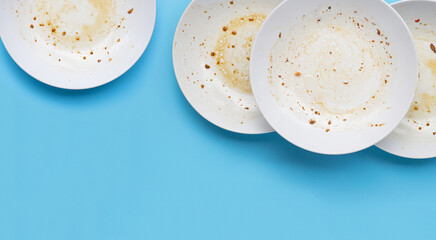 Dirty dishes on blue background.