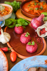 Muslim Ramadan iftar family dinner. Flat-lay of people feasting over table with Middle East food. Dates, dolma, kebab, flatbread, pide, borek, sweet, salad, top view. Ramazan fasting Turkish cuisine.