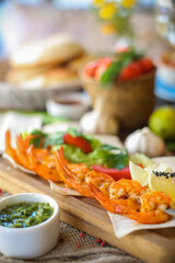 Muslim Ramadan iftar family dinner. Flat-lay of people feasting over table with Middle East food. Dates, dolma, kebab, flatbread, pide, borek, sweet, salad, top view. Ramazan fasting Turkish cuisine.