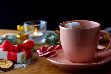 cup of hot cocoa with marshmallows with christmas decorations