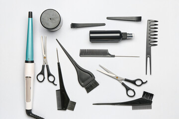 Set of hairdresser's tools on grey background