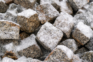 Snow covered walkway cubes paving granite stones