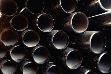 Black metal pipes and adapters of different diameters for gasification or water supply. Industrial...