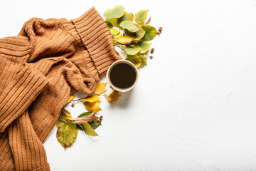Beautiful autumn composition with clothes and cup of coffee on white background