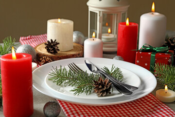 Concept of New year table setting with candles on gray table, close up