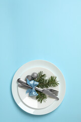 Plates with New year cutlery on blue background