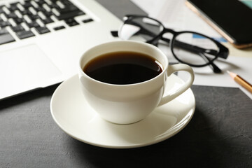 Concept of financial planning with cup of coffee on black table