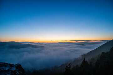 sunset over the mountains with valley fog