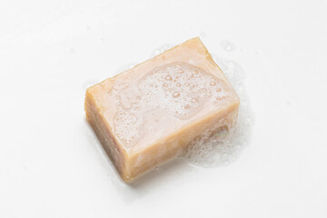 Soap bar and foam on white background, top view. Mockup for design