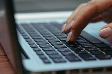 woman using laptop, searching the internet, viewing information, having a job at home