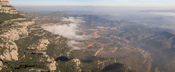 Panoramic aerial drone shot of Cap de Bou at Montserrat near Barcelona with morning fog