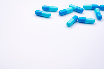 Blue capsule pills on white background. Pharmaceutical industry. Pharmacy or drugstore products....