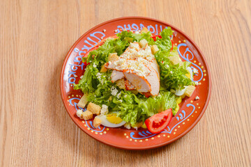Plate of Caesar Salad. Ukrainian concept, Italian cuisine. Delicious mayonnaise salad on a plate.