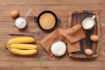 Fototapeta na wymiar Tasty banana pancakes with ingredients on wooden background