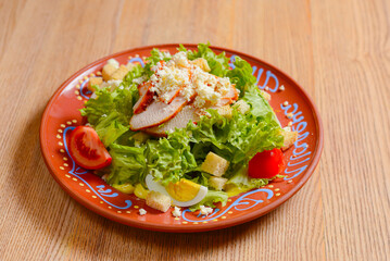 Plate of Caesar Salad. Ukrainian concept, Italian cuisine. Delicious mayonnaise salad on a plate.