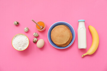 Tasty banana pancakes with ingredients on color background