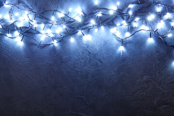 Glowing Christmas lights on dark background