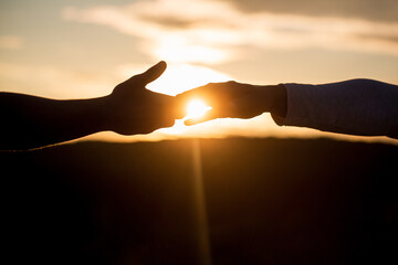 Outstretched hands, salvation, help silhouette, concept help. Giving a helping hand. Rescue,...