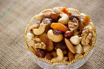 Mixed nuts in a glass plate. Healthy and natural nutrition .Cashew, Almond,, Hazelnut,, Fig,, Walnut,, Apricot,, Raisin,, Blueberry.