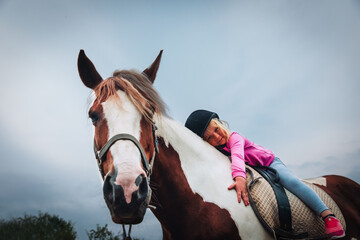 happy little girl hug horse, horse theraphy - 396254796