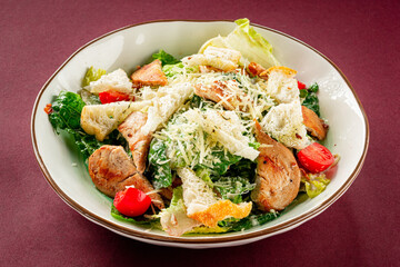 Caesar salad on burgundy background