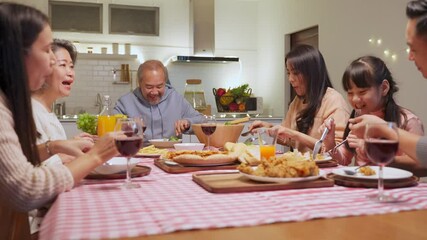 Group of Asian big family having dinner party together in the kitchen.