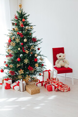 Fototapeta na wymiar Christmas tree with gifts interior decor for the new year white background